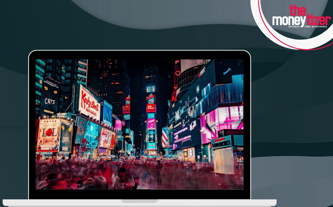  A laptop is displaying a photo of Time Square in New York City, which is known for its bright lights and billboards, with the text 'The Moneytizer - Optimize your ad revenues'.